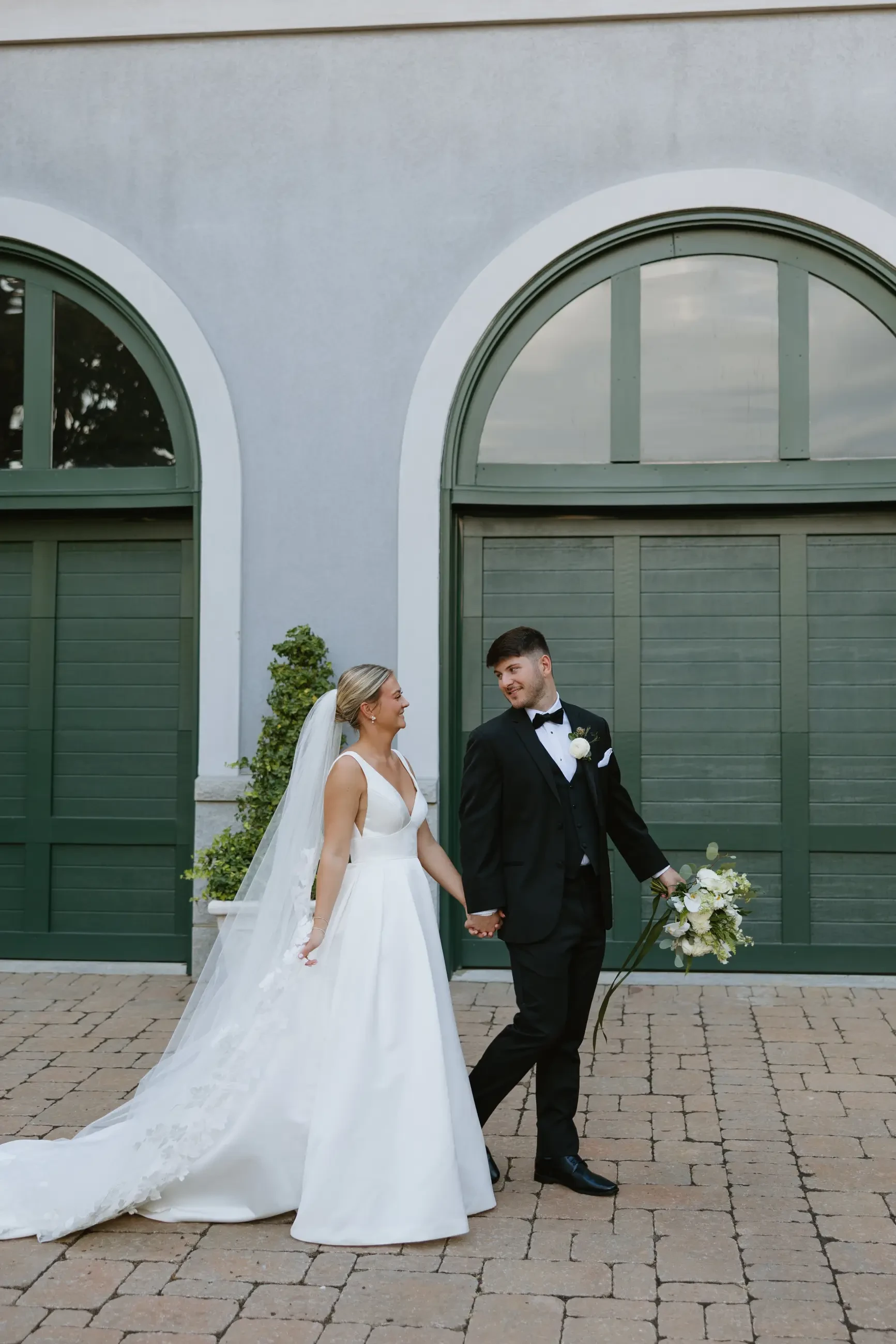 image shows sydney and jackson smiling at each other on their wedding day