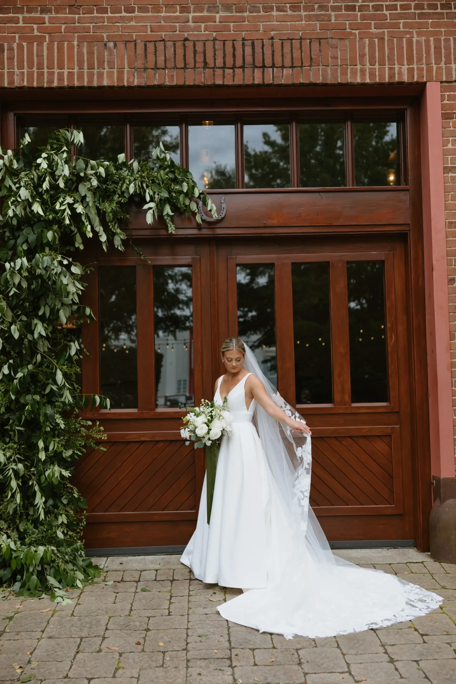 image shows sydney on her wedding day showing off her veil