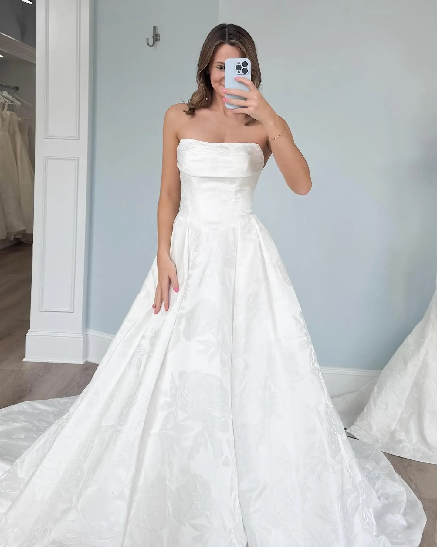 Model is wearing a strapless ball gown jacquard wedding dress